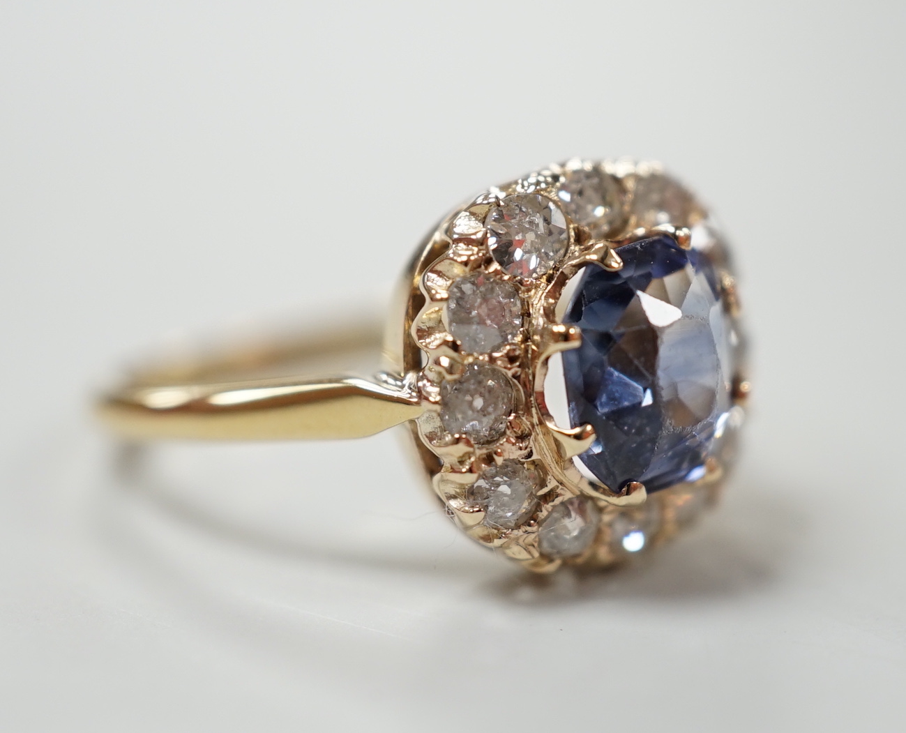 An 18ct, sapphire and diamond set cluster ring, size M, gross weight 3 grams.
